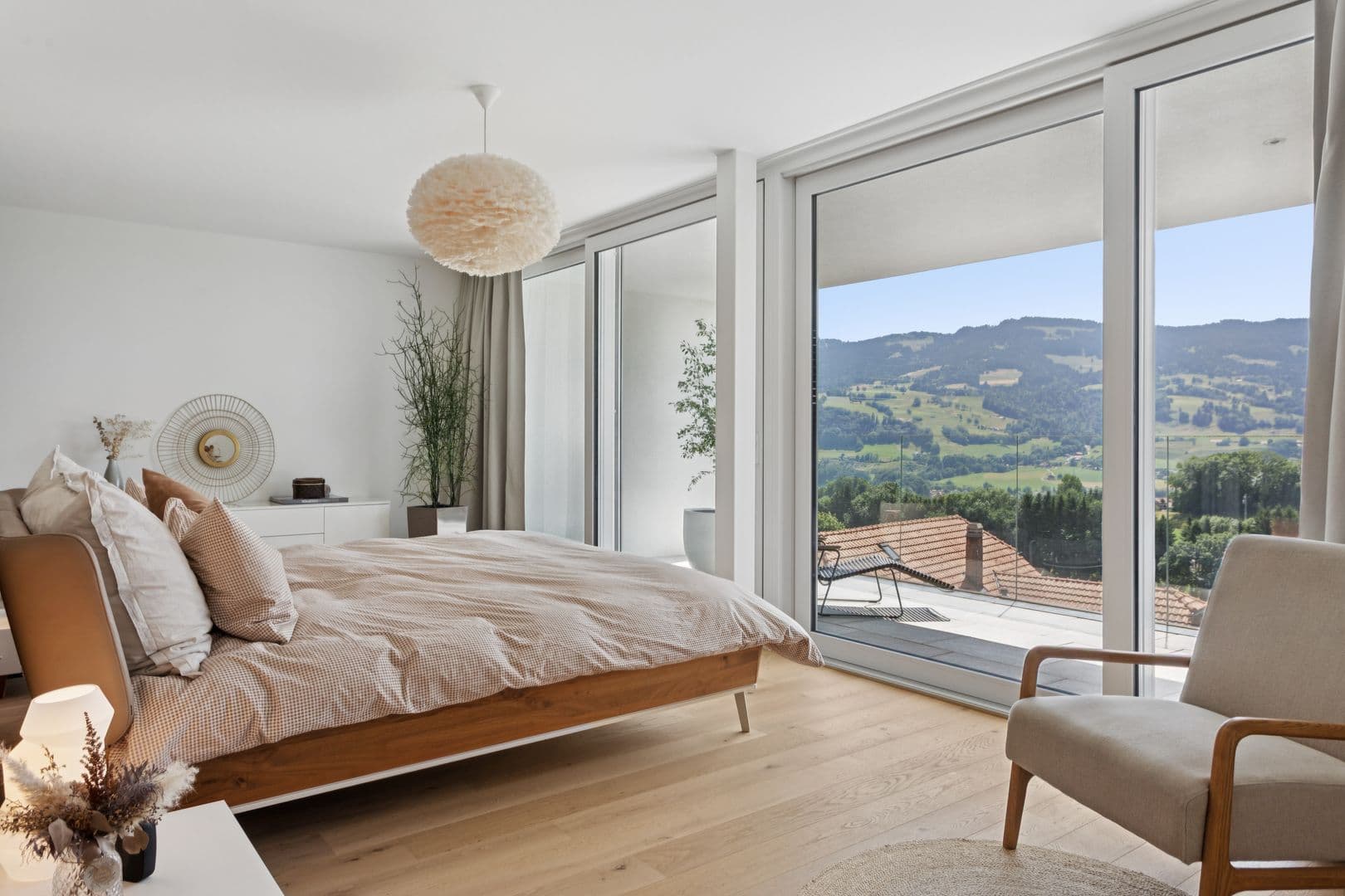 Elternsuite mit Zugang zum Balkon und herrlichem freien Blick auf die Berge, das Grün und den See